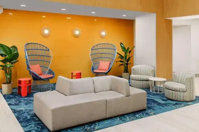 a living room with a couch and chairs at Hyatt Place across from Universal Orlando Resort in Orlando