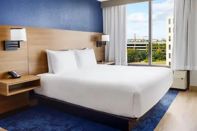 a large white bed in a room with a window at Hyatt Place across from Universal Orlando Resort in Orlando