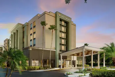 a rendering of the front of a hotel with palm trees at Hyatt Place Orlando / I-Drive / Convention Center in Orlando