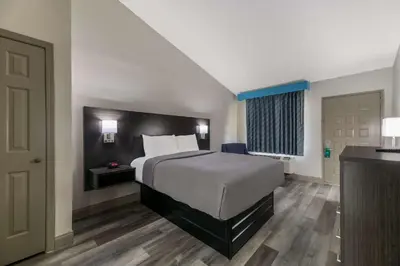 a hotel room with a bed and a door at Quality Inn & Suites Altamonte Springs Orlando-North in Orlando