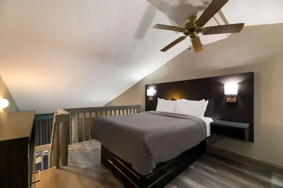 a bedroom with a bed and a ceiling fan at Quality Inn & Suites Altamonte Springs Orlando-North in Orlando