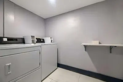 a kitchen with white walls and a counter with a dishwasher at Quality Inn & Suites Altamonte Springs Orlando-North in Orlando