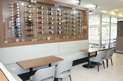 a dining room with a table and chairs and wine racks at Crowne Plaza Orlando - Lake Buena Vista by IHG in Orlando
