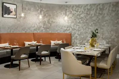 a dining room with tables and chairs and lights at Crowne Plaza Orlando - Lake Buena Vista by IHG in Orlando