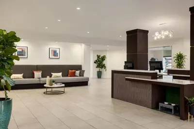 a lobby of a hotel with couches and plants at Crowne Plaza Orlando - Lake Buena Vista by IHG in Orlando