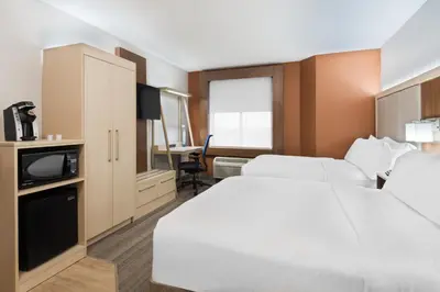 a hotel room with two beds and a tv at Holiday Inn Express & Suites - Nearest Universal Orlando by IHG in Orlando