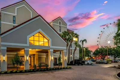 a large white building with a wheel in the background at Sonesta ES Suites Orlando International Drive in Orlando