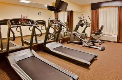 a gym with several exercise bikes and tread machines at Holiday Inn Express-International Drive by IHG in Orlando