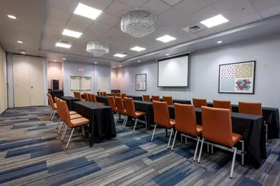 a conference room with a long table and chairs at Holiday Inn Express-International Drive by IHG in Orlando