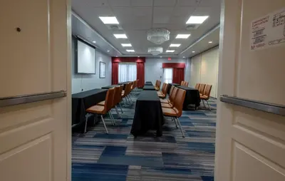 a conference room with a long table and chairs at Holiday Inn Express-International Drive by IHG in Orlando
