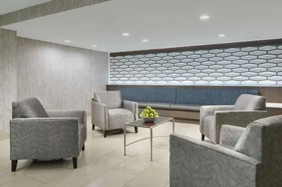 a waiting room with chairs and a table at DoubleTree by Hilton Orlando Airport Hotel in Orlando