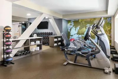 a fitness room with a gym with a treadmill at DoubleTree by Hilton Orlando Airport Hotel in Orlando