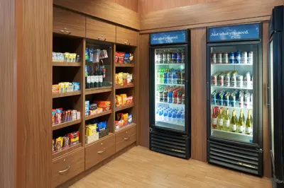 a store aisle with two refrigerators and drinks at Fairfield Inn & Suites by Marriott Orlando International Drive/Convention Center in Orlando