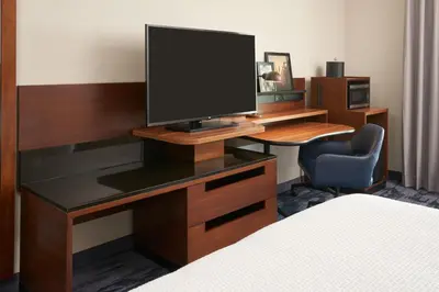a room with a desk with a television on it at Fairfield Inn & Suites by Marriott Orlando International Drive/Convention Center in Orlando