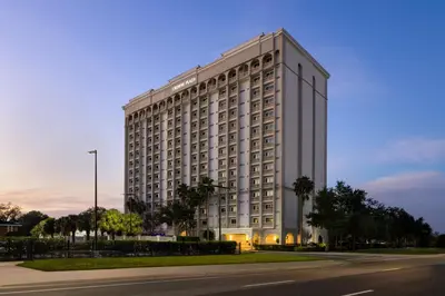 a large white building on the side of a street at Crowne Plaza Orlando-Downtown by IHG in Orlando