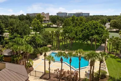 an aerial view of a pool with palm trees at Holiday Inn Orlando International Airport by IHG in Orlando