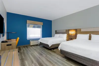 a hotel room with two beds and a television at Holiday Inn Express Orlando-Ocoee East by IHG in Orlando