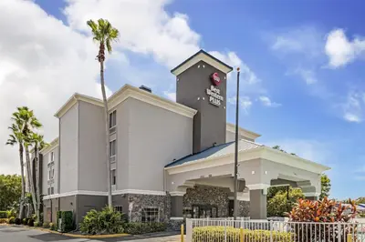 a building with a clock tower with a palm tree at Best Western Plus Sanford Airport/Lake Mary Hotel in Sanford