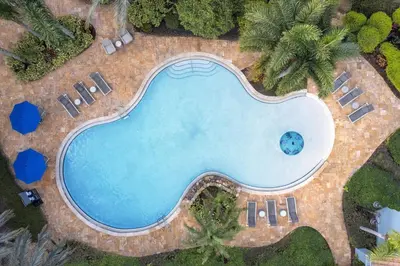 an overhead view of a swimming pool with palm trees at Homewood Suites by Hilton Lake Buena Vista Orlando - Newly Renovated! in Orlando