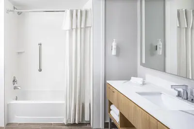 a bathroom with a tub and a sink and a shower at Homewood Suites by Hilton Lake Buena Vista Orlando - Newly Renovated! in Orlando