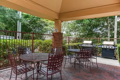 a patio with a table and chairs and a grill at Candlewood Suites Lake Mary by IHG in Lake Mary