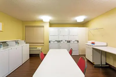 a kitchen with a table and chairs in a room at MainStay Suites Orlando Altamonte Springs in Orlando