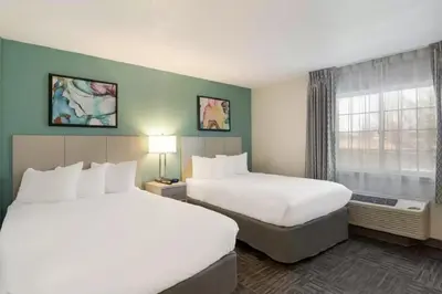 a hotel room with two beds and a window at MainStay Suites Orlando Altamonte Springs in Orlando