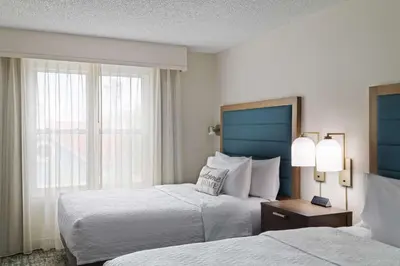 a hotel room with two beds and a window at Homewood Suites by Hilton Lake Mary Orlando North in Lake Mary