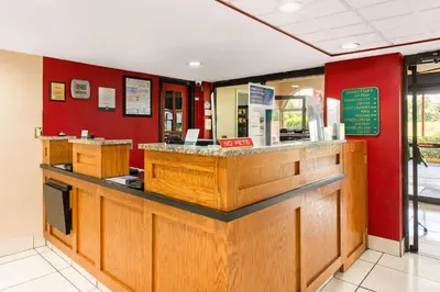 a fast food restaurant with a counter and red walls at Quality Inn & Suites Orlando Airport in Orlando