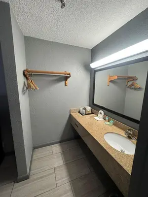 a bathroom with a sink and a mirror at Budget Inn Sanford International Airport in Sanford