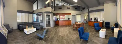 a lobby with couches and chairs in a building at Budget Inn Sanford International Airport in Sanford