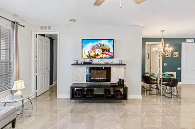a living room with a fireplace and a tv at Hidden Treasure in Orlando
