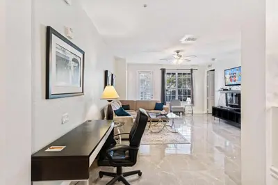 a living room with a desk and a dining room at Hidden Treasure in Orlando