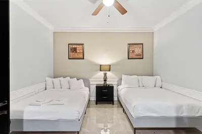 a bedroom with two beds and a ceiling fan at Hidden Treasure in Orlando