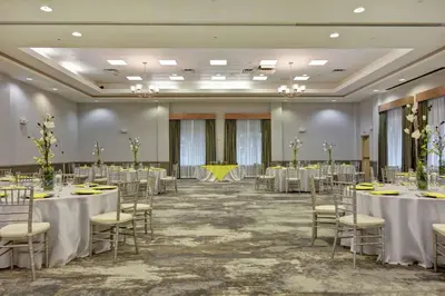 a banquet hall with tables and chairs in a room at Hilton Garden Inn Orlando Lake Buena Vista in Orlando