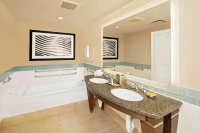 a bathroom with two sinks and a tub at Hilton Grand Vacations Club Parc Soleil Orlando in Orlando