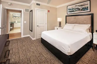 a bedroom with a large bed and a bathroom at Hilton Grand Vacations Club Parc Soleil Orlando in Orlando