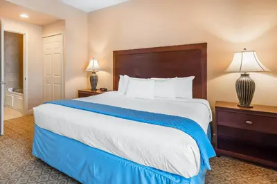 a large bed in a hotel room with two lamps at Bluegreen Vacations Fountains, an Ascend Collection Resort in Orlando