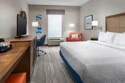 a hotel room with a bed and a flat screen tv at Hampton Inn & Suites at Lake Mary Colonial Townpark in Lake Mary