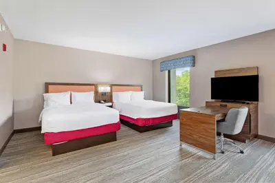a hotel room with two beds and a flat screen tv at Hampton Inn & Suites Orlando-Apopka in Orlando
