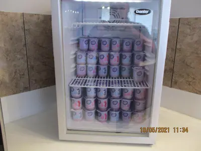 a refrigerator filled with bottles of milk at Quality Inn & Suites Kissimmee near Main Gate in Orlando