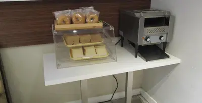 a counter with a toaster oven and some food at Quality Inn & Suites Kissimmee near Main Gate in Orlando