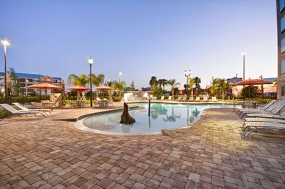 a swimming pool with a statue in the middle of it at Homewood Suites by Hilton Orlando Theme Parks in Orlando