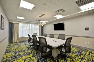 a conference room with a table and chairs at Homewood Suites by Hilton Orlando Theme Parks in Orlando