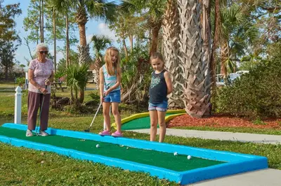 two little girls playing golf on a trampoline at Tropical Palms Resort in Orlando