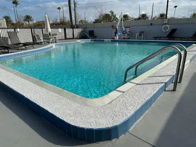 a large swimming pool with blue water at Magic Key - Near Disney in Kissimmee