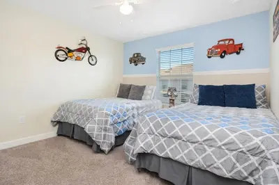 a bedroom with two beds and a motorcycle on the wall at Four Bedrooms Home with Pool 3079 in Kissimmee