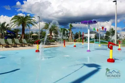a large swimming pool with a water park at Four Bedrooms Home with Pool 3079 in Kissimmee
