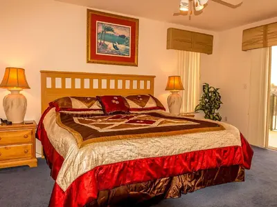 a bedroom with a large bed with two lamps on a table at Suaimhneas in Kissimmee