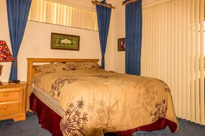 a bedroom with a bed with blue drapes at Suaimhneas in Kissimmee
